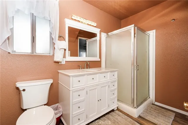 a bathroom with a toilet a sink a vanity and mirror