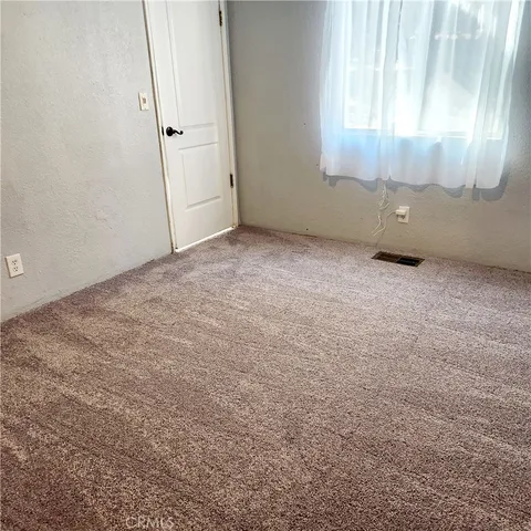 a view of balcony with wooden floor and fence