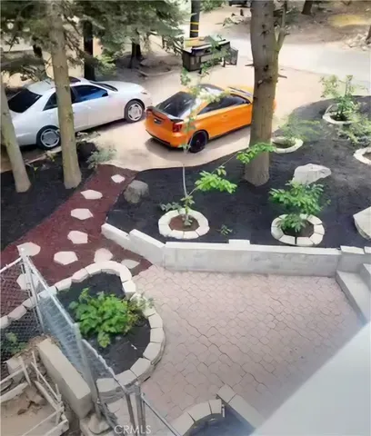 a backyard of a house with lots of green space and fountain