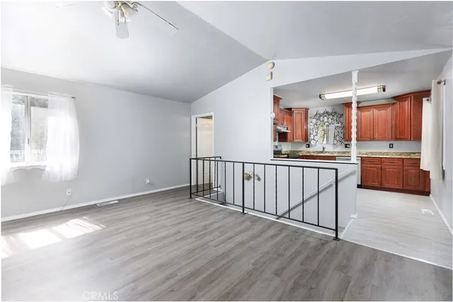 a view of a kitchen with a sink and dishwasher wooden floor