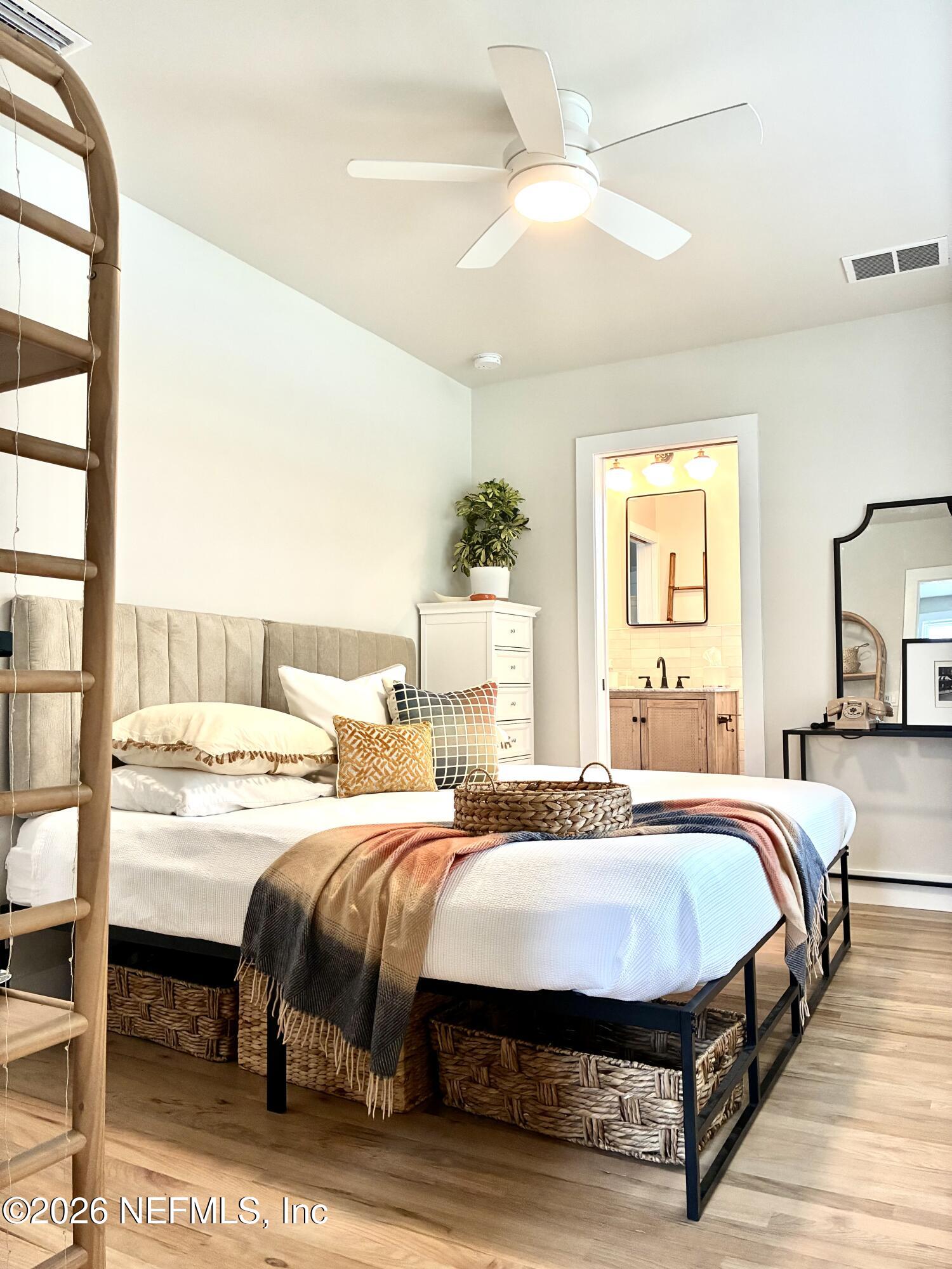 1011 Inwood Terrace Jacksonville, FL 32207 - Photo 15 of 56 a bedroom with a bed a chandelier and next to a window