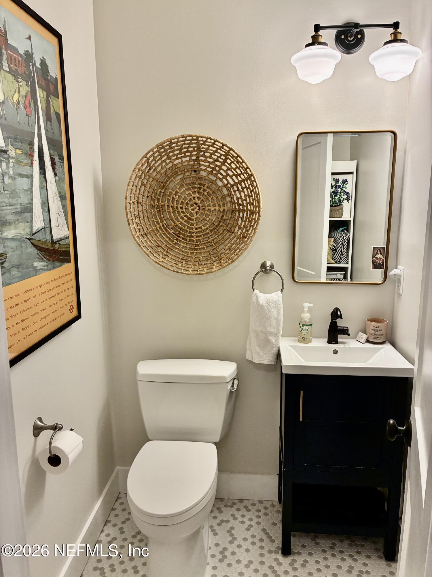 1011 Inwood Terrace Jacksonville, FL 32207 - Photo 20 of 56 a bathroom with a toilet a sink and mirror