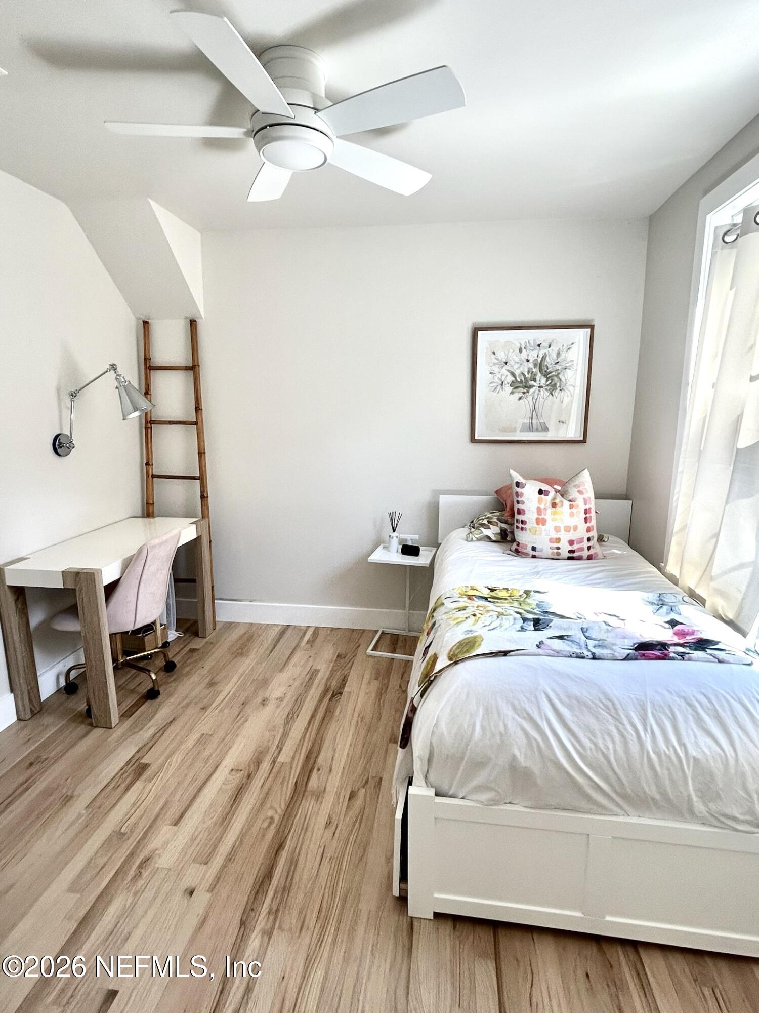 1011 Inwood Terrace Jacksonville, FL 32207 - Photo 22 of 56 a bedroom with a bed a table and painting on the wall
