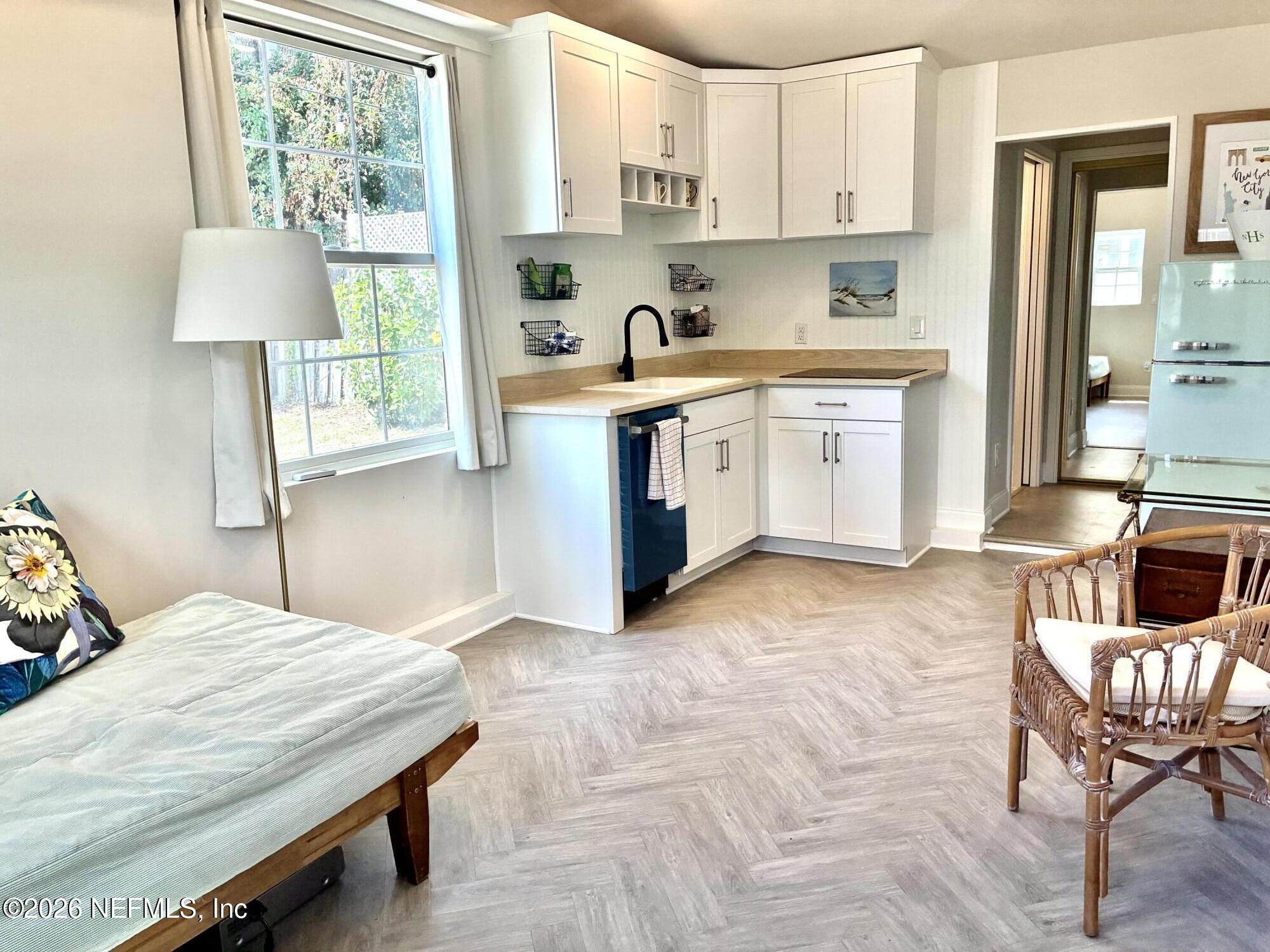 1011 Inwood Terrace Jacksonville, FL 32207 - Photo 30 of 56 a kitchen with a stove a table and chairs in it