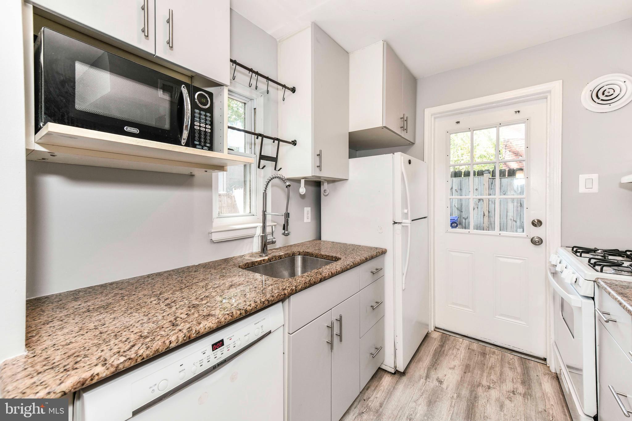 3210 9th Street South Arlington, VA 22204 - Photo 12 of 26 a kitchen with granite countertop a sink and refrigerator