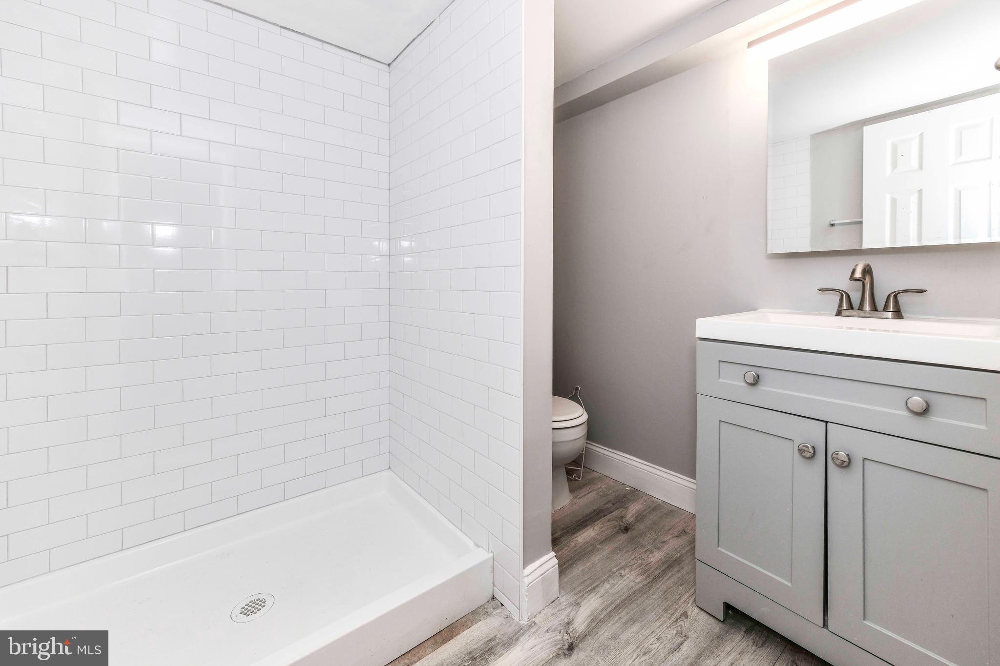 3210 9th Street South Arlington, VA 22204 - Photo 17 of 26 a bathroom with a sink a toilet and shower