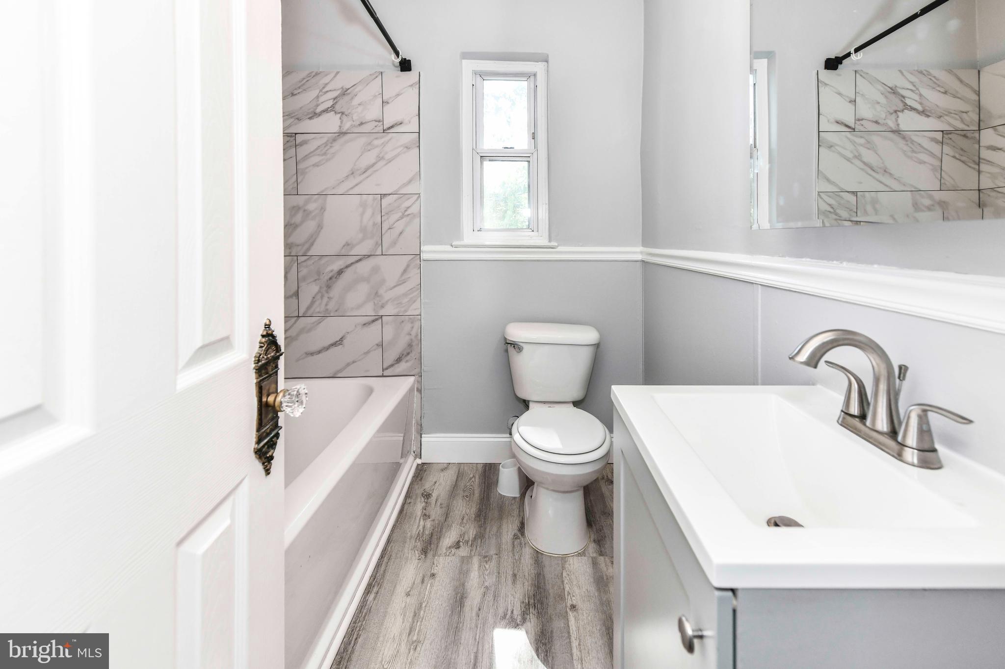 3210 9th Street South Arlington, VA 22204 - Photo 20 of 26 a bathroom with a sink a toilet and bathtub