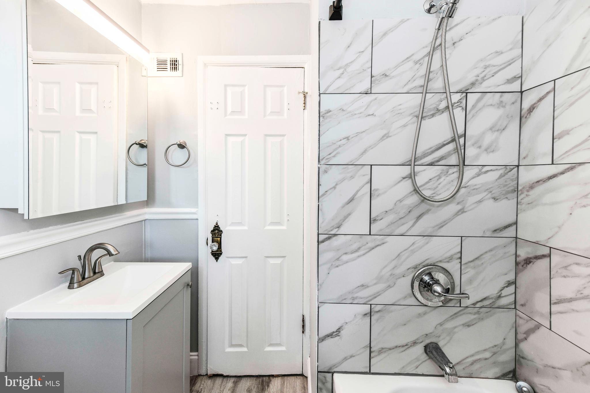 3210 9th Street South Arlington, VA 22204 - Photo 21 of 26 a bathroom with a sink and mirror