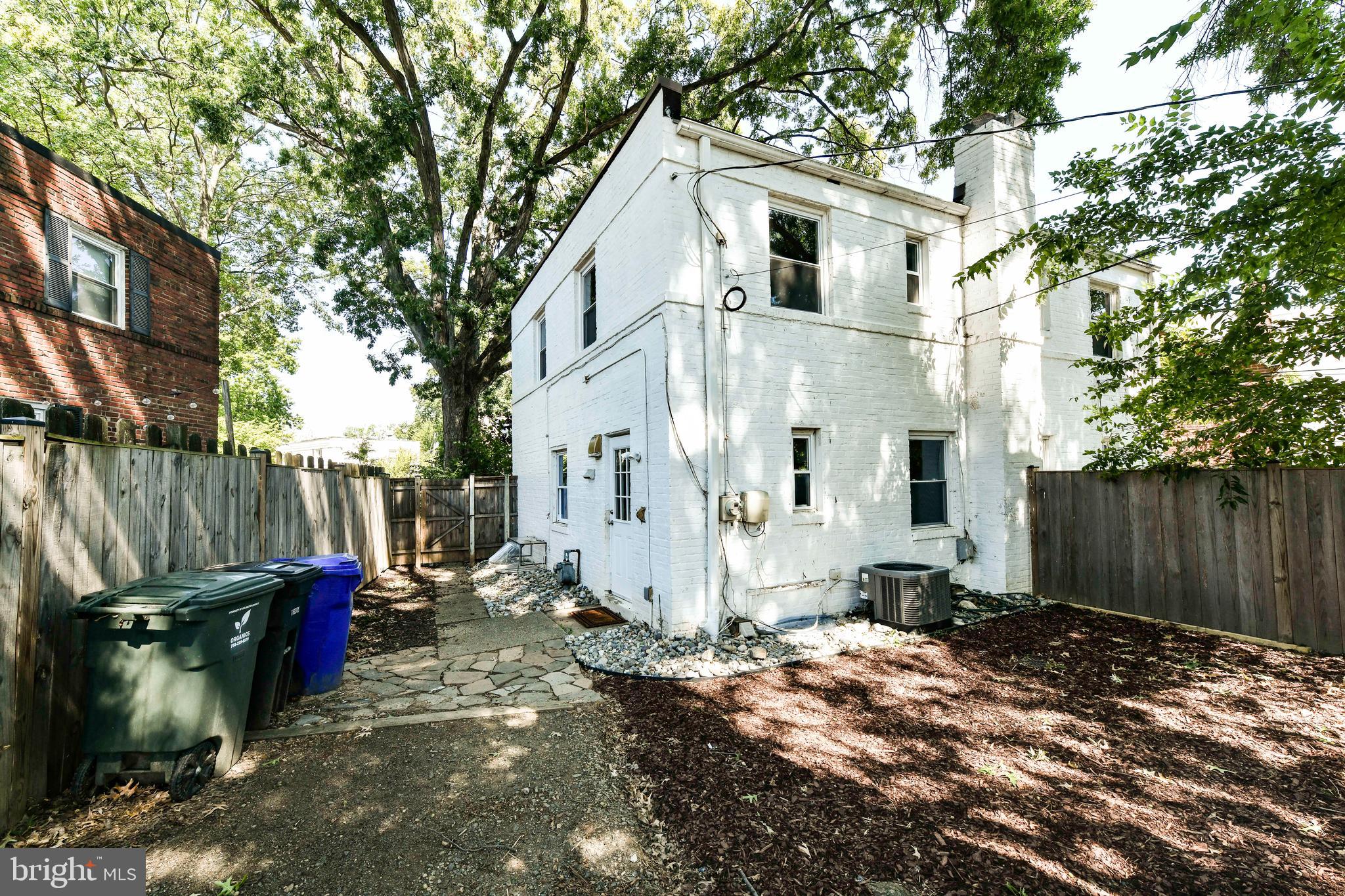 3210 9th Street South Arlington, VA 22204 - Photo 24 of 26 a view of a white house with a small yard and large tree