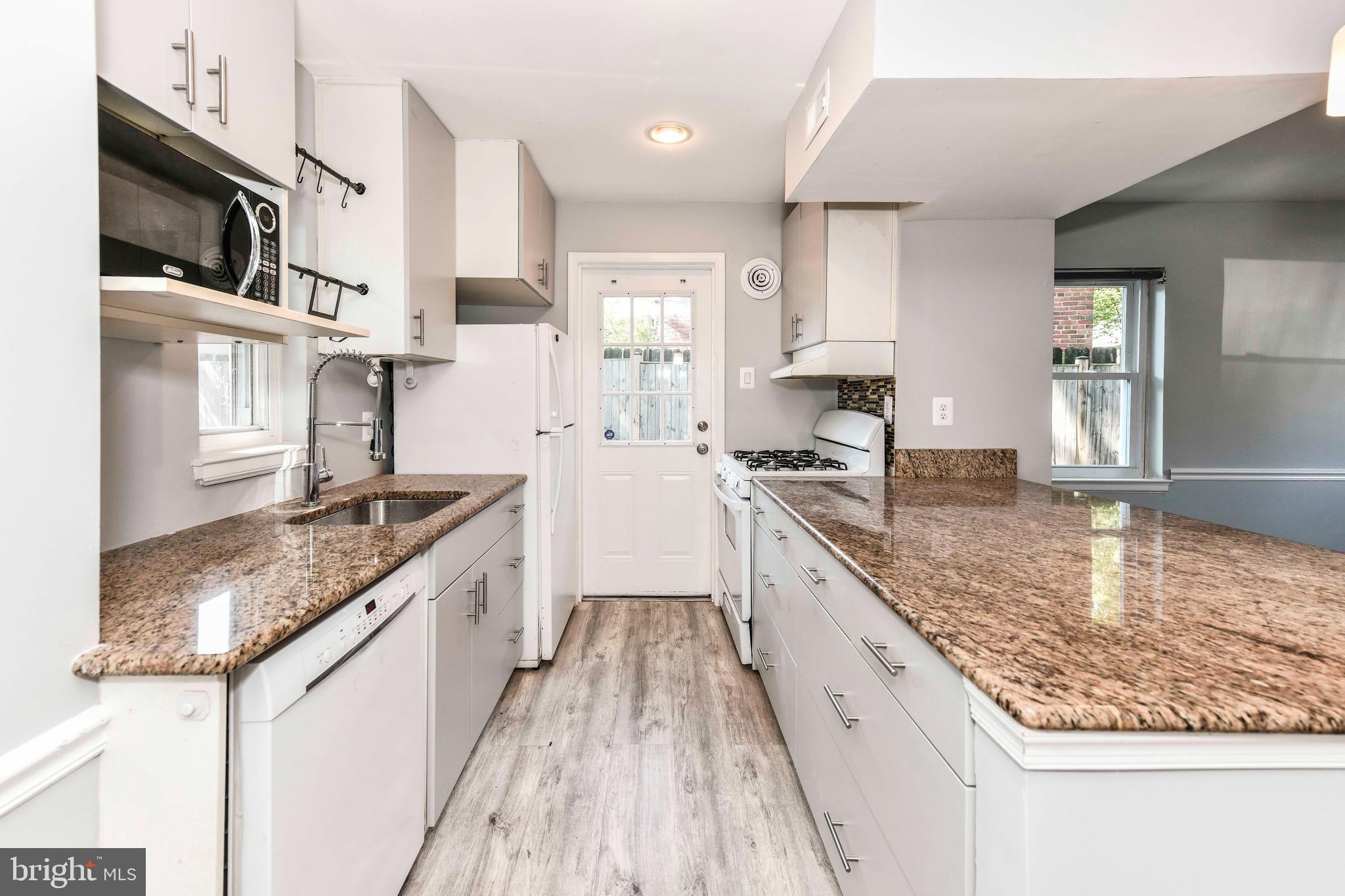 3210 9th Street South Arlington, VA 22204 - Photo 10 of 26 a large kitchen with stainless steel appliances granite countertop a lot of counter space and wooden floor