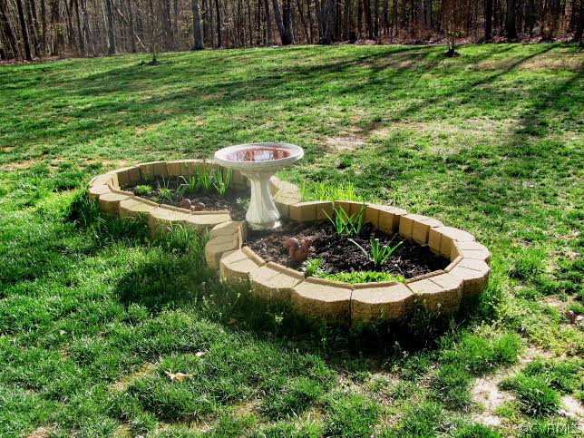 2862 Roundabout Road Louisa, VA 23093 - Photo 14 of 24 a view of a backyard with plants and swimming pool