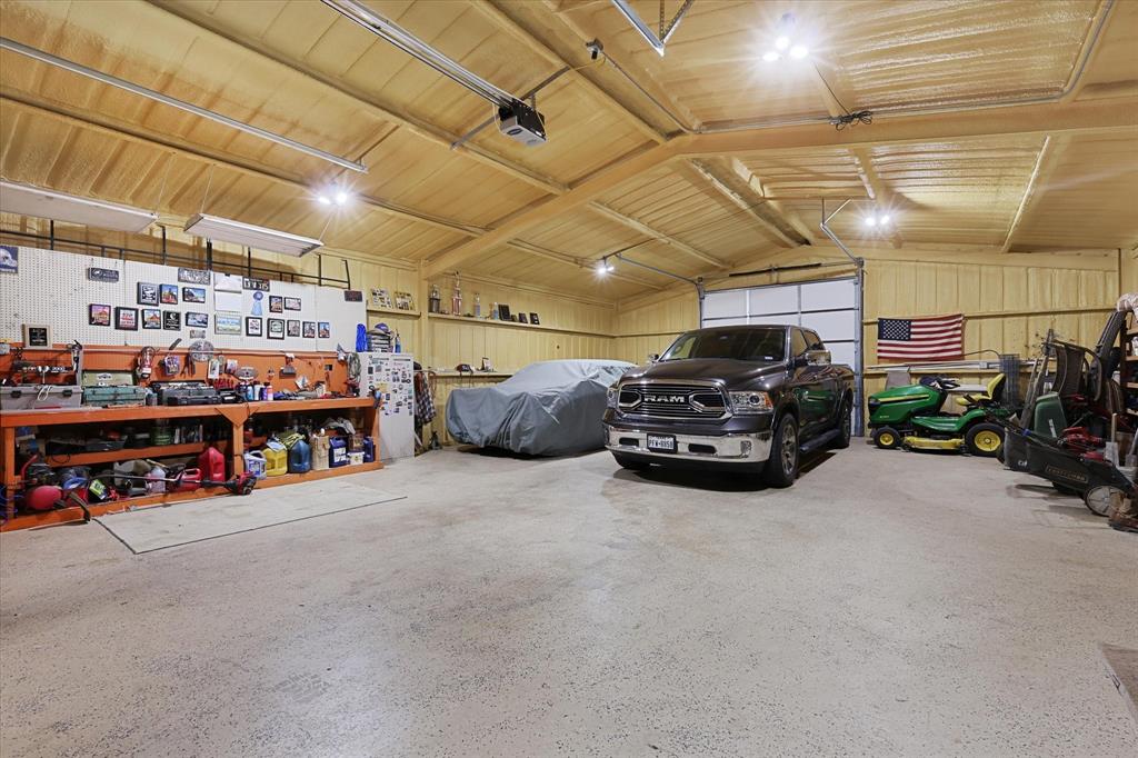2375 County Road 4010 Decatur, TX 76234 - Photo 23 of 34 Garage with a workshop area, metal wall, and a garage door opener