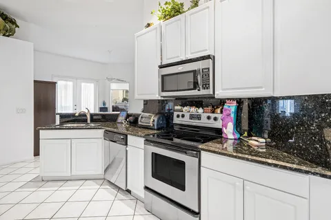 a kitchen with cabinets appliances and a sink