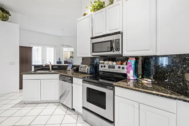a kitchen with cabinets appliances and a sink