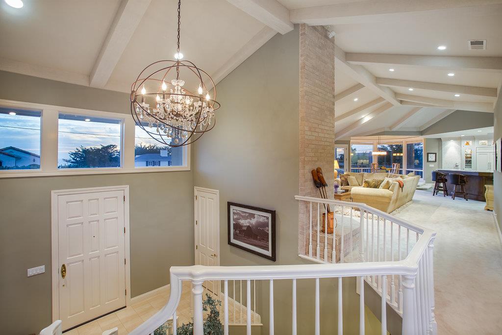 1003 Rodeo Road Pebble Beach, CA 93953 - Photo 12 of 24 a view of a dining room with furniture a chandelier and wooden floor