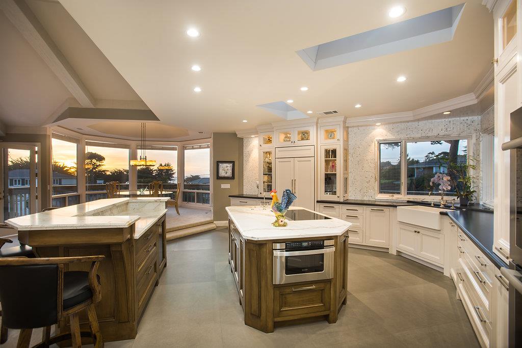 1003 Rodeo Road Pebble Beach, CA 93953 - Photo 13 of 24 a room with stainless steel appliances kitchen island granite countertop a sink and cabinets