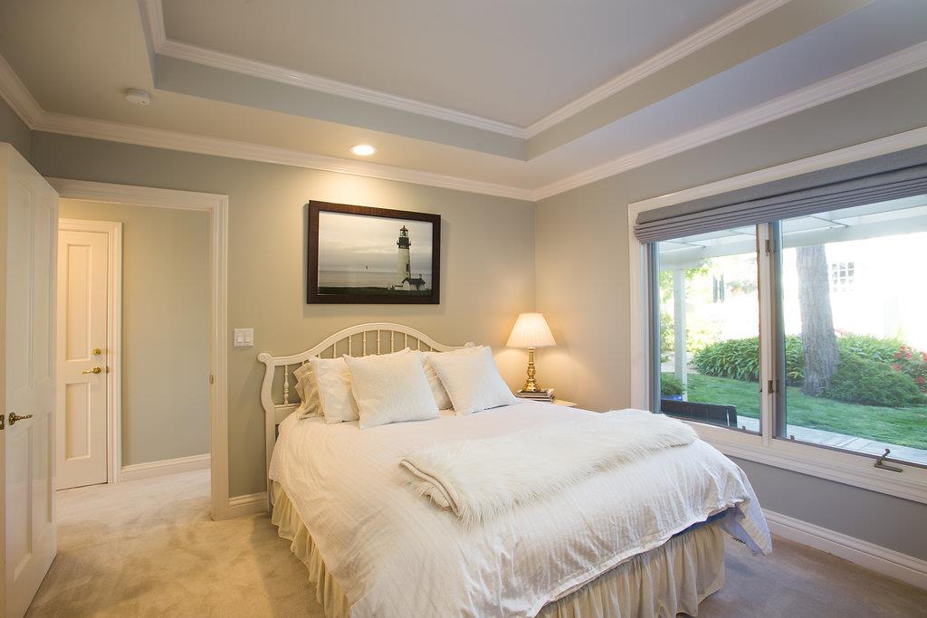 1003 Rodeo Road Pebble Beach, CA 93953 - Photo 14 of 24 a bedroom with a bed and a large window