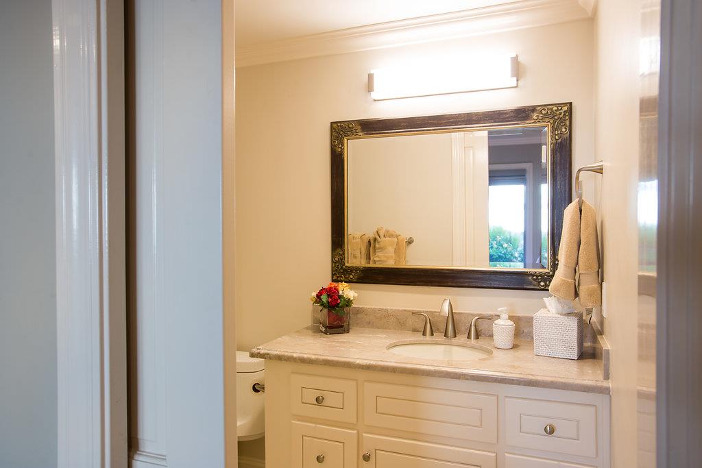 1003 Rodeo Road Pebble Beach, CA 93953 - Photo 15 of 24 a bathroom with a granite countertop sink and a mirror