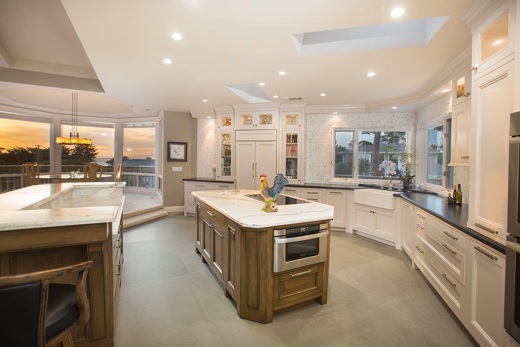 1003 Rodeo Road Pebble Beach, CA 93953 - Photo 3 of 24 a kitchen with stainless steel appliances granite countertop a stove and a refrigerator