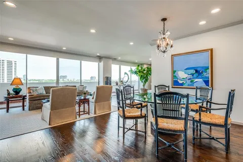 a view of a dining room with furniture a chandelier and wooden floor