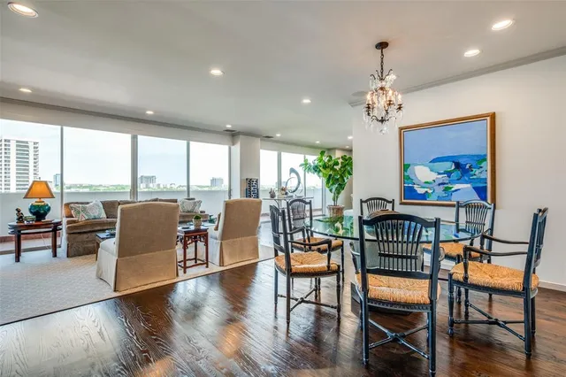 a view of a dining room with furniture a chandelier and wooden floor