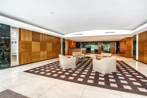 a front view of a building with trees