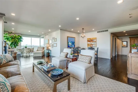 a living room with furniture kitchen view and a table