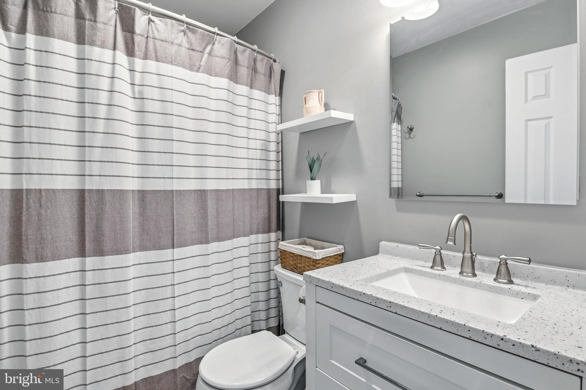 129 Catherine Street, Unit 3 Telford, PA 18969 - Photo 22 of 34 a bathroom with a granite countertop sink toilet and mirror
