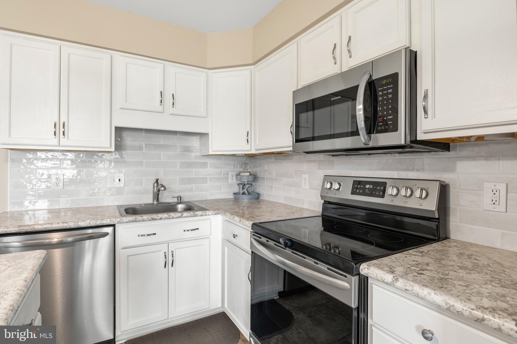 129 Catherine Street, Unit 3 Telford, PA 18969 - Photo 10 of 34 a kitchen with granite countertop a stove sink and cabinets