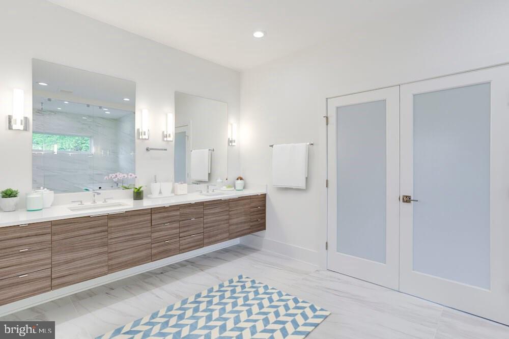 2925 West Ox Road Herndon, VA 20171 - Photo 15 of 38 a bathroom with a sink a mirror and a shower