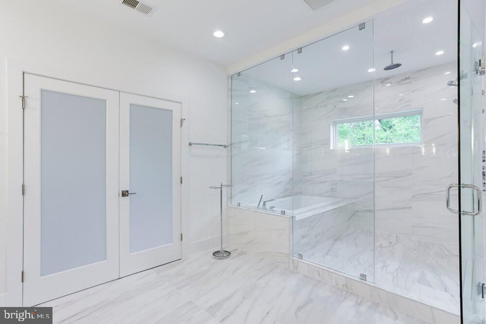 2925 West Ox Road Herndon, VA 20171 - Photo 17 of 38 a bathroom with a bathtub and a shower