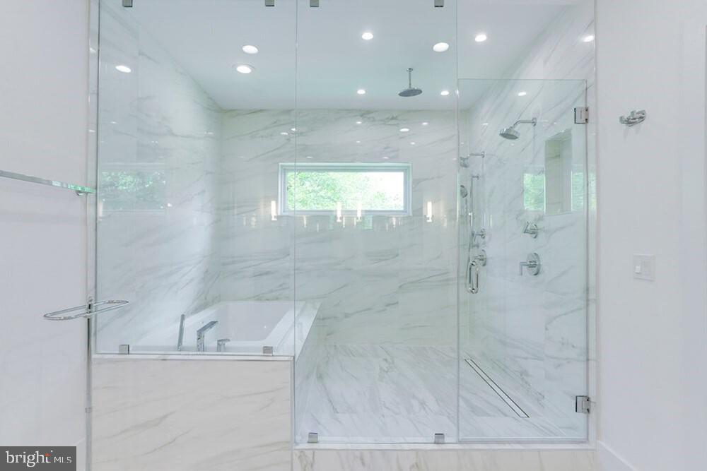 2925 West Ox Road Herndon, VA 20171 - Photo 19 of 38 a bathroom with a bathtub and a shower