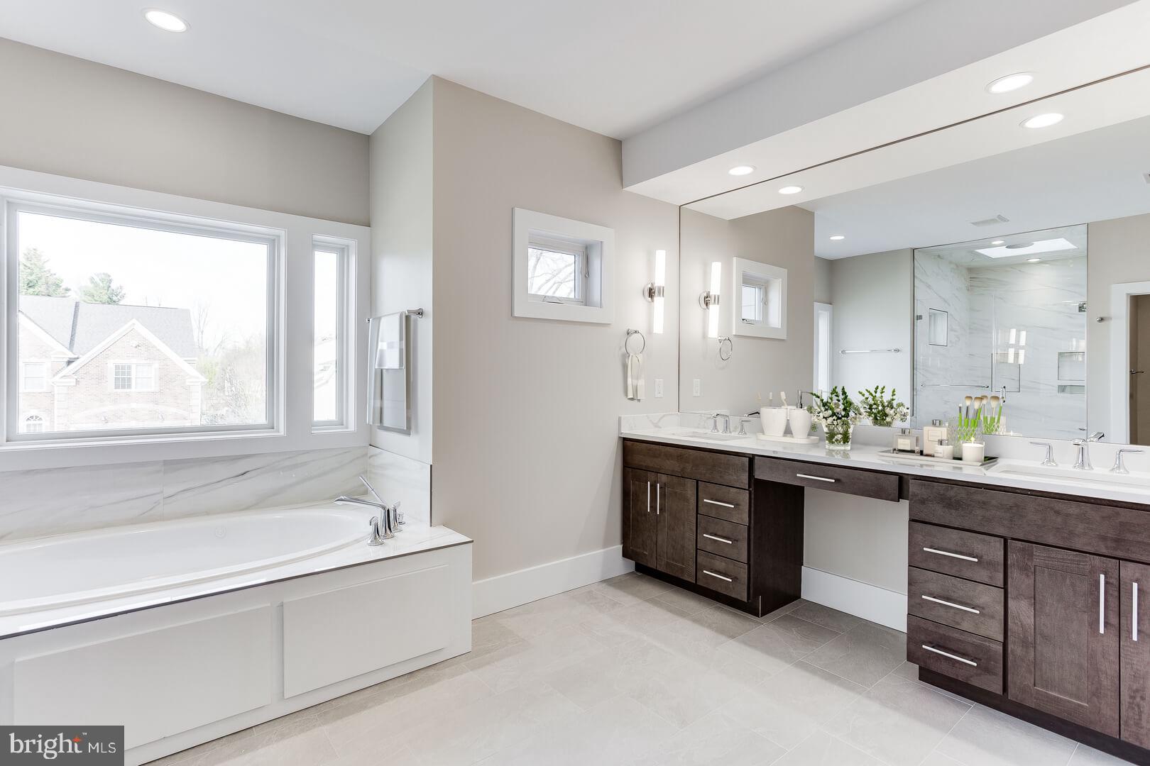 2925 West Ox Road Herndon, VA 20171 - Photo 34 of 38 a spacious bathroom with a tub sink and mirror