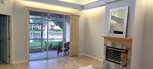 a view of an entryway with wooden floor and a fireplace