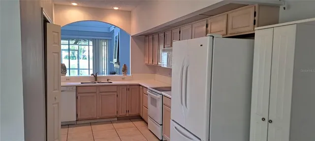 a kitchen with stainless steel appliances a refrigerator and a sink