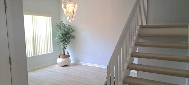 a view of an entryway with wooden floor and windows