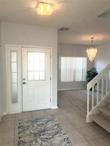 a view of a livingroom with wooden floor and stairs