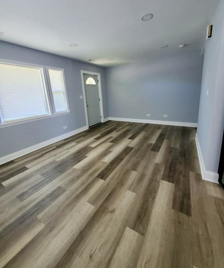 2820 12th Avenue Broadview, IL 60155 - Photo 4 of 7 a view of empty room with wooden floor and fan