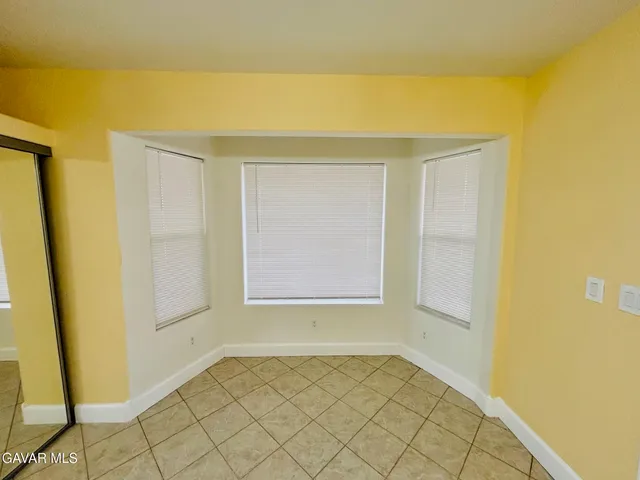 a view of a room with wooden floor and chair
