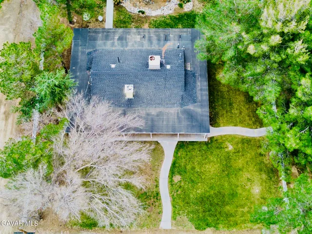 an aerial view of a house with a yard