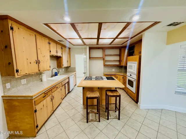 a kitchen with stainless steel appliances granite countertop a sink and cabinets