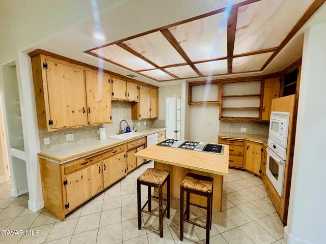 a kitchen with a stove a sink and a refrigerator