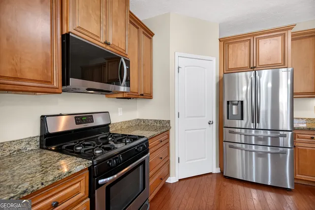 a kitchen with a stove microwave and refrigerator