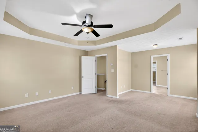 a view of a room with a ceiling fan