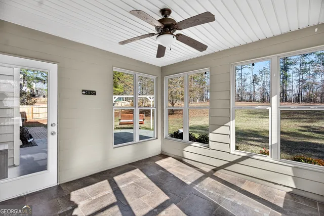 a living room with hardwood floor and windows