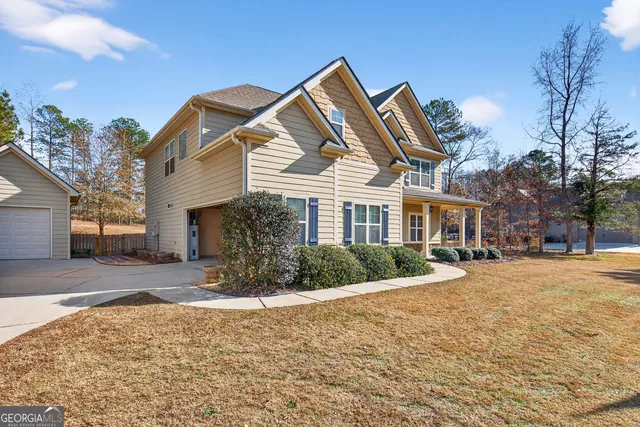 a view of a house with a yard covered in snow