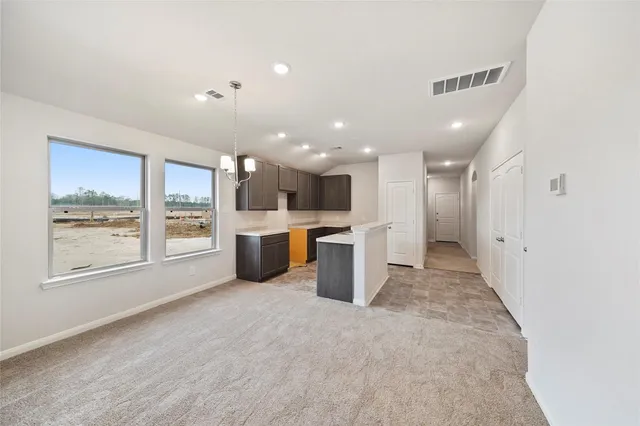 a large white kitchen with a large window