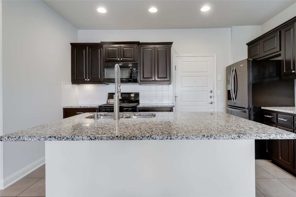6814 East Riverside Drive, Unit 32 Austin, TX 78741 - Photo 10 of 27 a kitchen with stainless steel appliances granite countertop a sink a stove and microwave