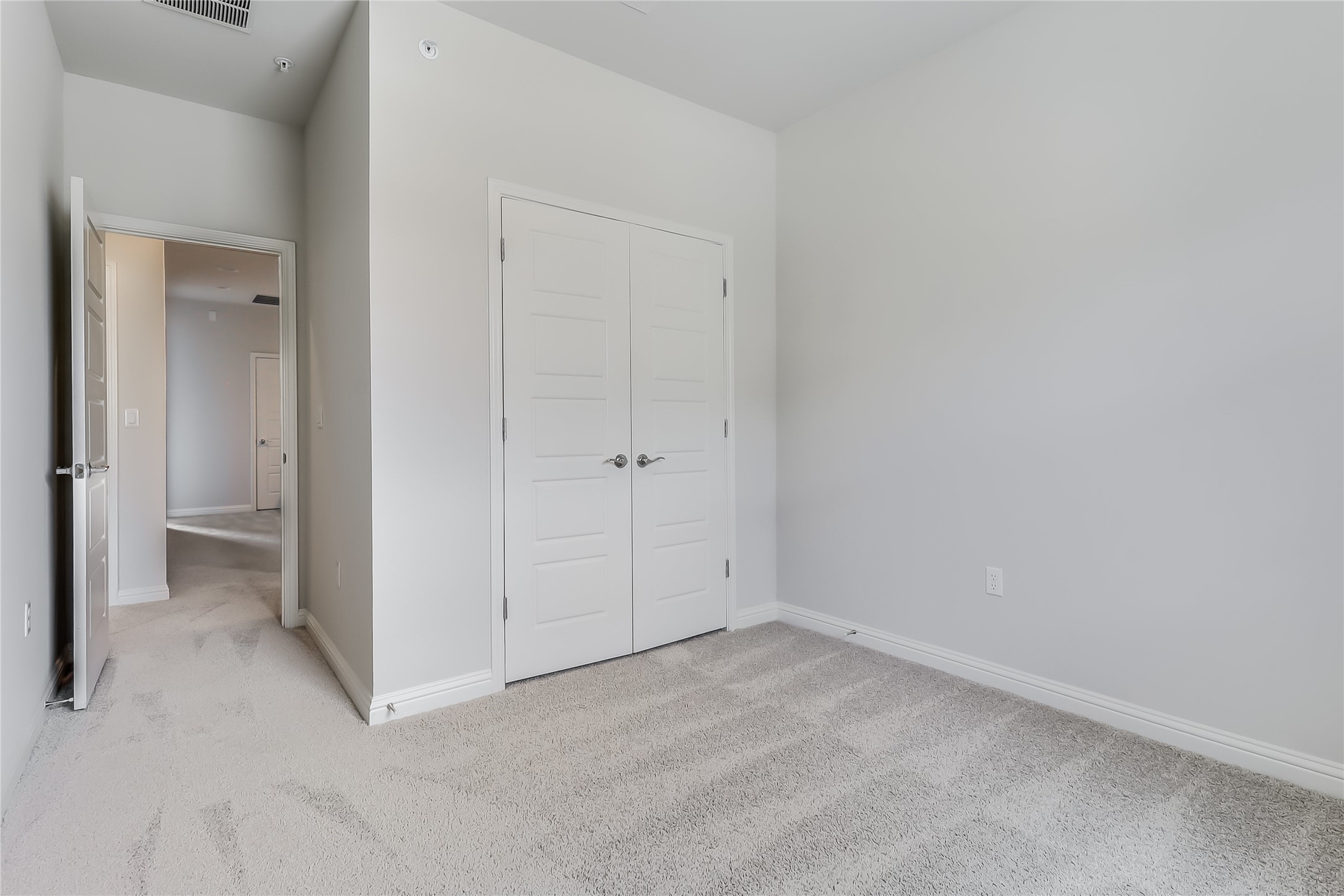 6814 East Riverside Drive, Unit 32 Austin, TX 78741 - Photo 17 of 26 One of the secondary bedrooms offers a walk-in closet while the other comes with a spacious closet with dual doors.