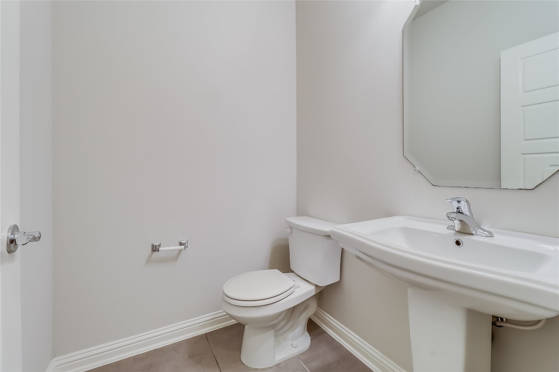 6814 East Riverside Drive, Unit 32 Austin, TX 78741 - Photo 22 of 27 a bathroom with a sink a toilet and mirror